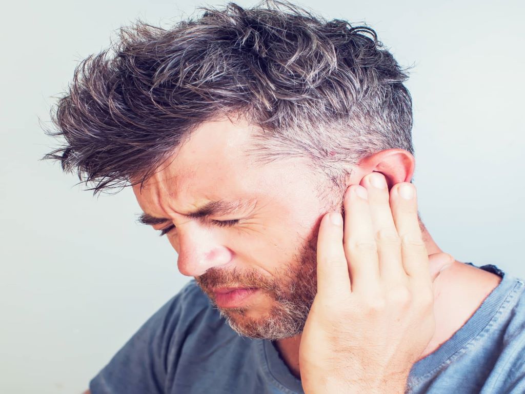 Tinnitus or Ringing or buzzing noise in one or both ears that may be constant or come and go, often associated with hearing loss.