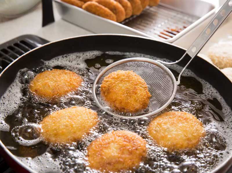 How to minimize the absorption of oil while deep frying?