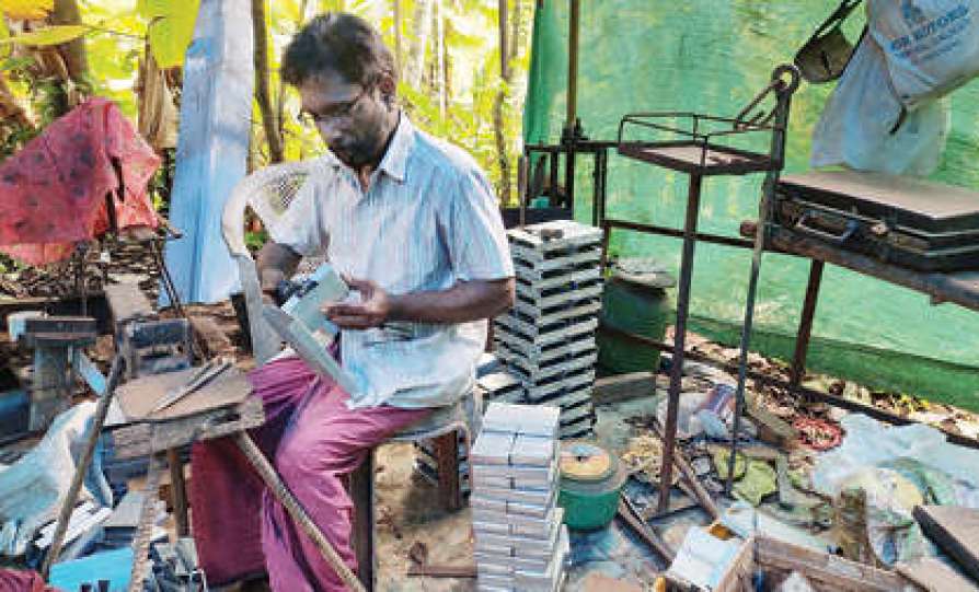 ramakrishnan with his arecanut peeling machine